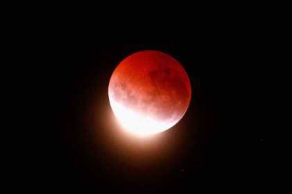 AUCKLAND, NEW ZEALAND - APRIL 04: A blood red moon lights up the sky during a total lunar eclipse on April 4, 2015 in Auckland, New Zealand. The shortest total lunar eclipse, or "blood moon", of the century will last just a few minutes. (Photo by Phil Walter/Getty Images)